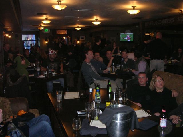 large group of people in pub watching football