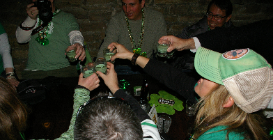 people sitting at a table taking green shots