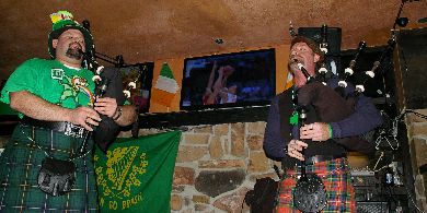 two men playing bagpipes